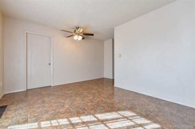 empty room featuring ceiling fan and a textured ceiling