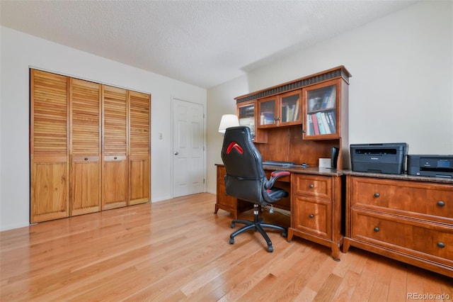 office area featuring light hardwood / wood-style flooring and a textured ceiling