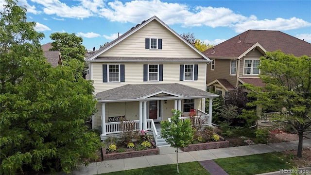 american foursquare style home with covered porch