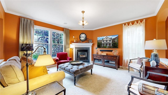 carpeted living area featuring crown molding, a glass covered fireplace, and baseboards
