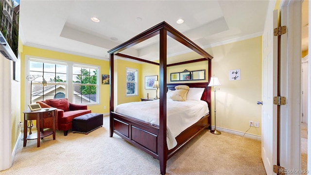 bedroom featuring light colored carpet, crown molding, baseboards, recessed lighting, and a tray ceiling