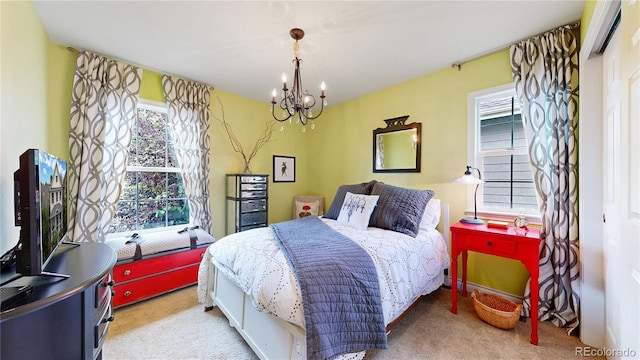 bedroom with carpet, multiple windows, and a chandelier