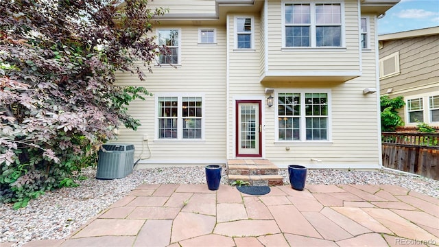 back of house featuring central air condition unit and a patio