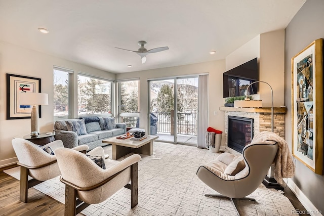 living room with ceiling fan and light hardwood / wood-style flooring