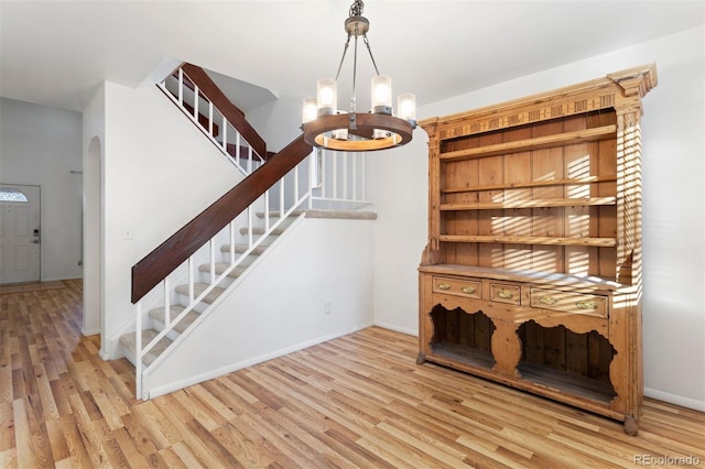 interior space with wood-type flooring and a chandelier