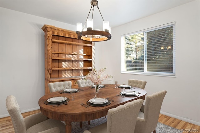 dining room with a notable chandelier and light hardwood / wood-style floors