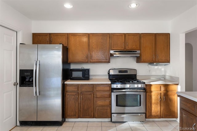 kitchen with appliances with stainless steel finishes and light tile patterned floors