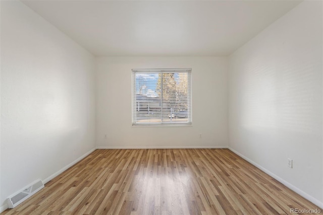 spare room with light hardwood / wood-style flooring