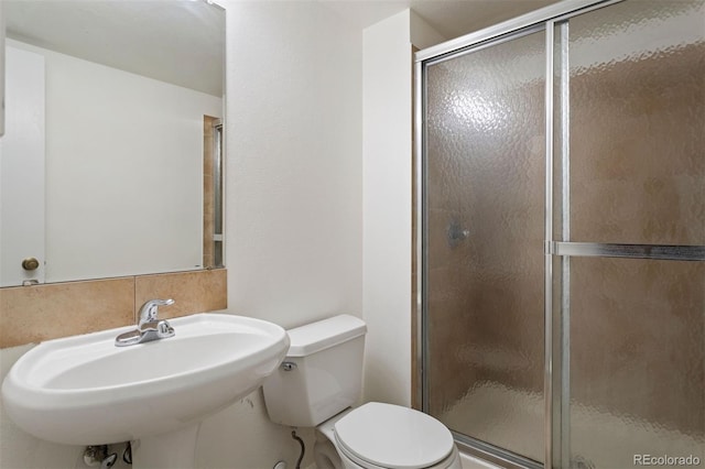 bathroom with sink, toilet, and walk in shower