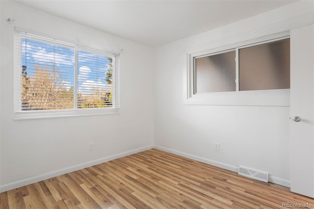 spare room with light hardwood / wood-style floors