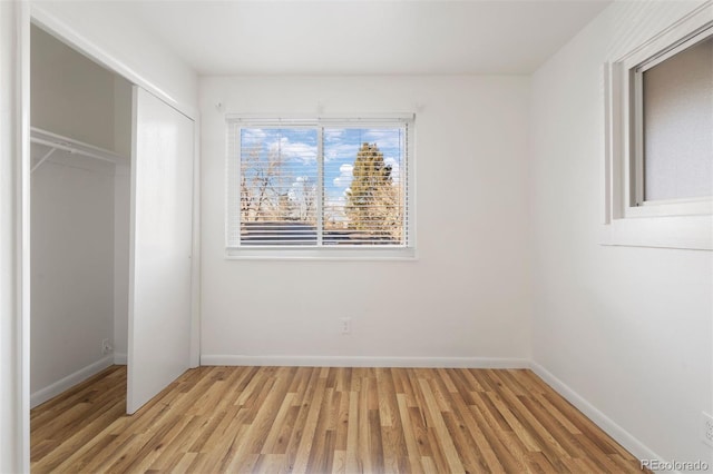 unfurnished bedroom featuring light hardwood / wood-style floors and a closet