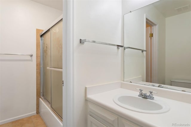 full bathroom featuring tile patterned flooring, combined bath / shower with glass door, sink, and toilet