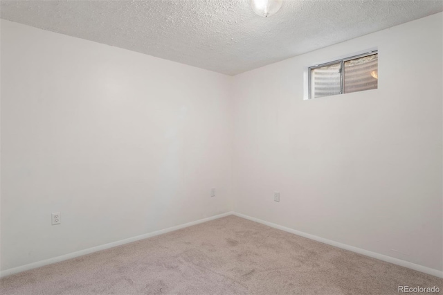 carpeted spare room with a textured ceiling