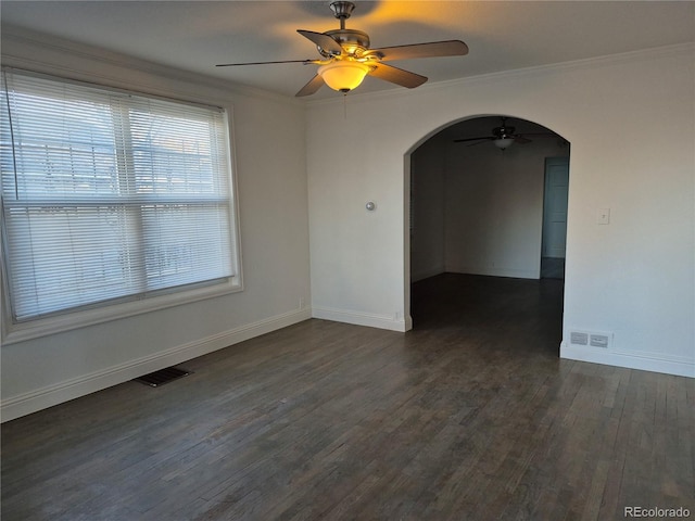 unfurnished room featuring ceiling fan, dark wood-type flooring, and ornamental molding