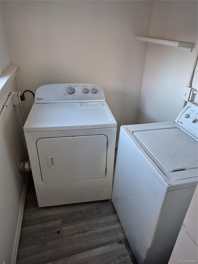 laundry area with dark hardwood / wood-style flooring and washer and clothes dryer