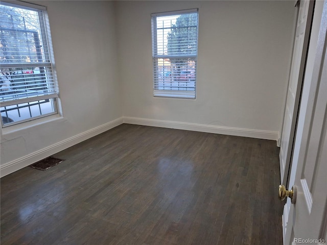 unfurnished room featuring dark hardwood / wood-style floors