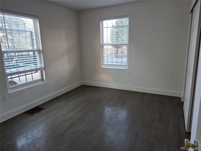 spare room featuring dark wood-type flooring