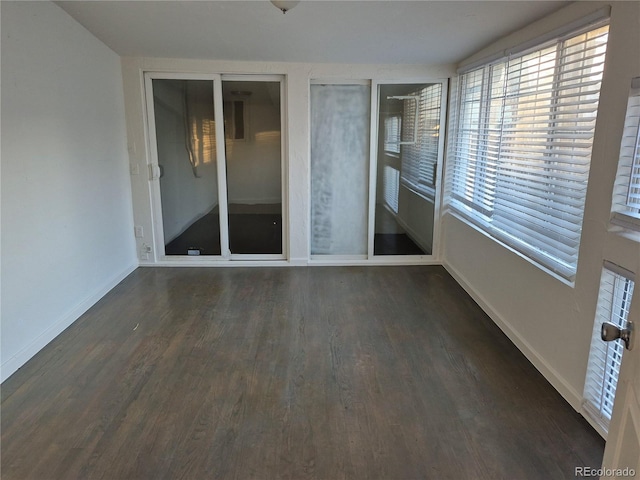 unfurnished room featuring dark wood-type flooring