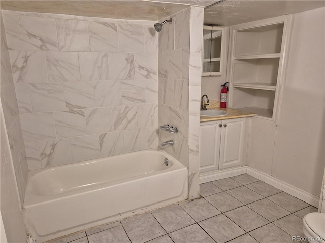 full bathroom with tile patterned floors, toilet, vanity, and tiled shower / bath