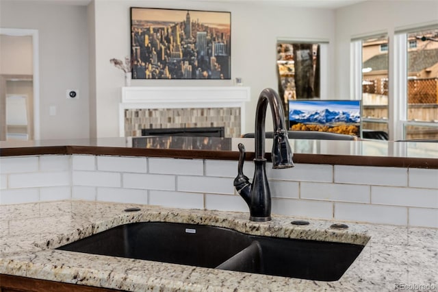 kitchen with a sink and a tile fireplace