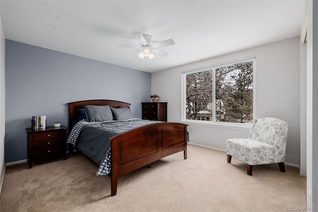 bedroom featuring ceiling fan, baseboards, and light colored carpet