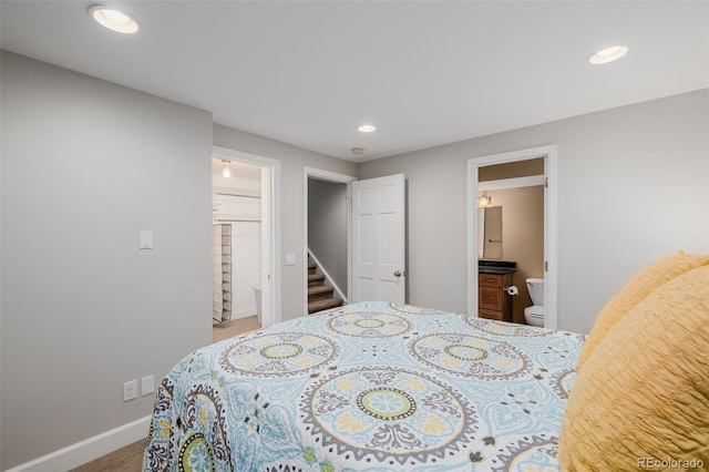 carpeted bedroom with recessed lighting, baseboards, and ensuite bathroom