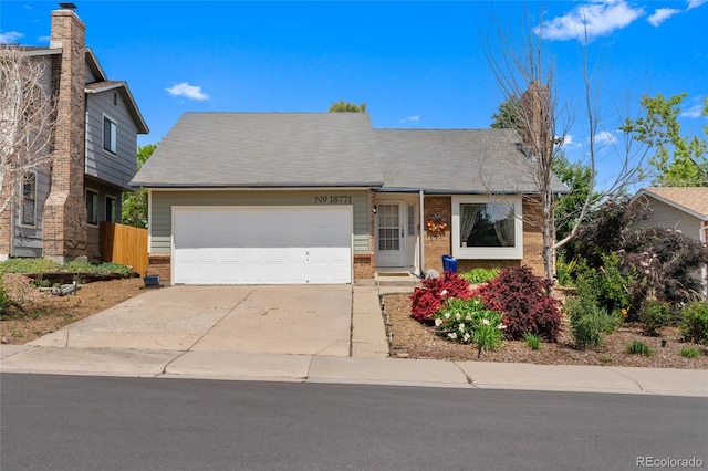 18771 Mexico Dr E, Aurora, CO 80017 - view of front of home with brick siding, driveway, and a garage