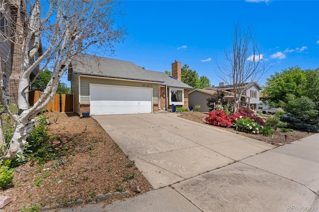 18771 Mexico Dr E, Aurora, CO 80017 - view of front of house with concrete driveway, a garage, brick siding, and a chimney