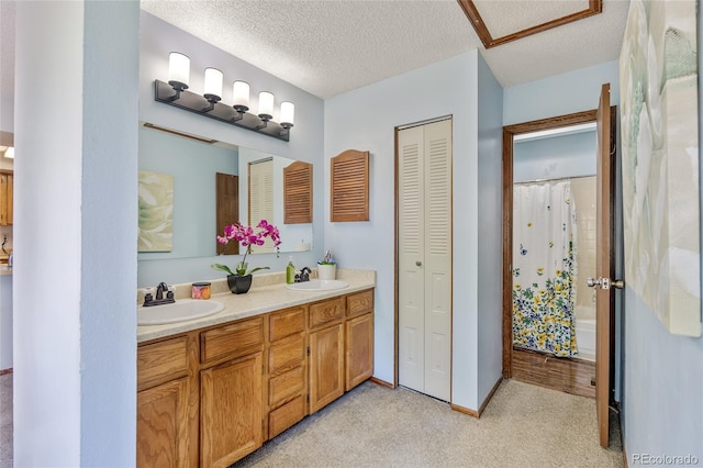 18771 Mexico Dr E, Aurora, CO 80017 - full bathroom with a closet, double vanity, a textured ceiling, and baseboards