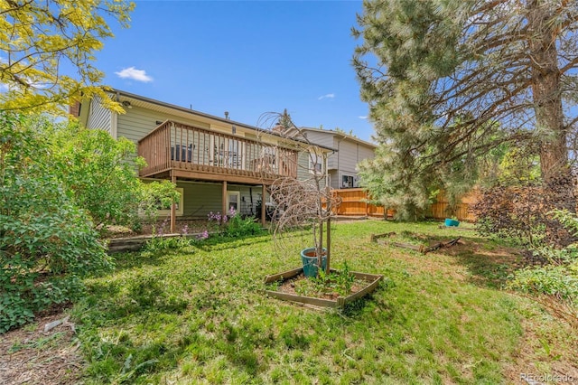 18771 Mexico Dr E, Aurora, CO 80017 - rear view of property with a vegetable garden and a wooden deck