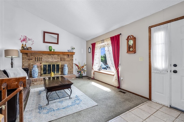 18771 Mexico Dr E, Aurora, CO 80017 - carpeted living area with lofted ceiling, a fireplace, tile patterned flooring, and baseboards