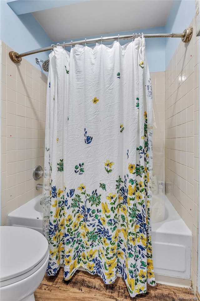 18771 Mexico Dr E, Aurora, CO 80017 - full bathroom featuring shower / bath combination with curtain, toilet, and wood finished floors