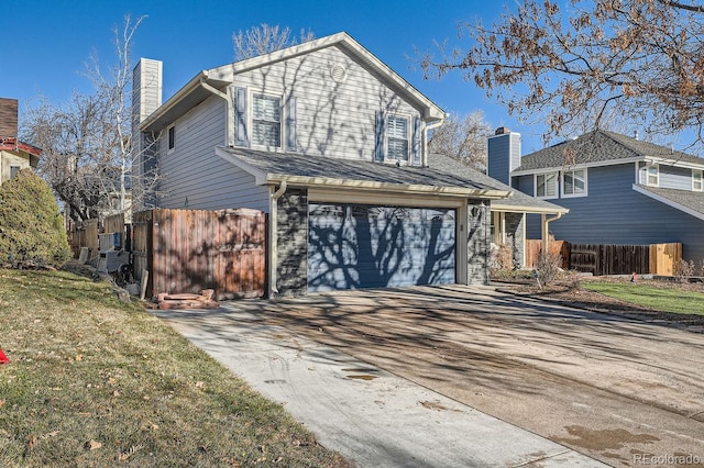 view of property with a front yard and a garage