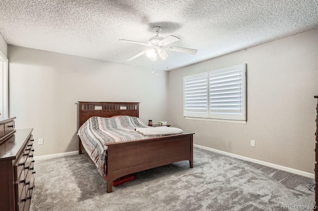 bedroom with ceiling fan, light carpet, and a textured ceiling