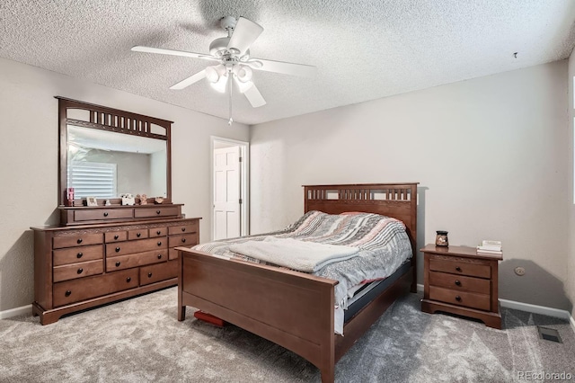 bedroom with a textured ceiling, dark carpet, and ceiling fan