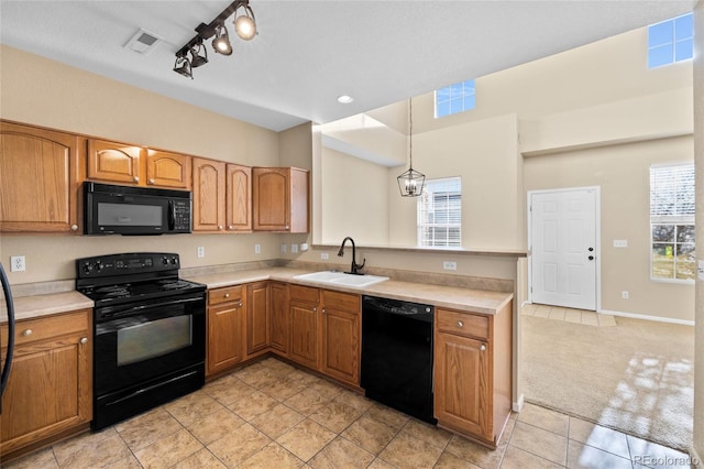 kitchen with sink, a notable chandelier, light colored carpet, decorative light fixtures, and black appliances