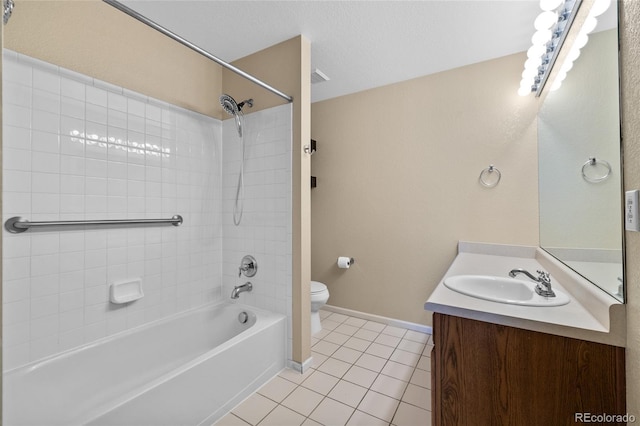 full bathroom with vanity, tile patterned floors, tiled shower / bath, toilet, and a textured ceiling