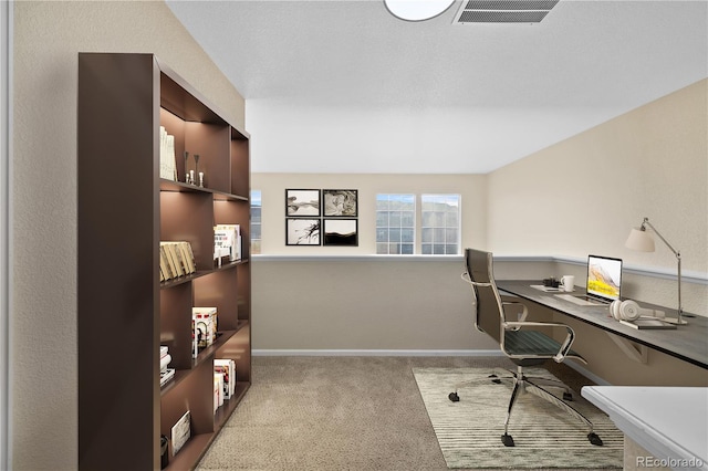 carpeted home office with built in desk