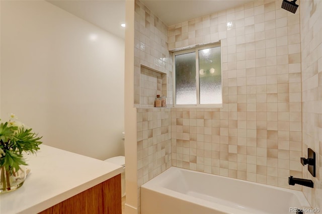 full bathroom with vanity, toilet, and tiled shower / bath