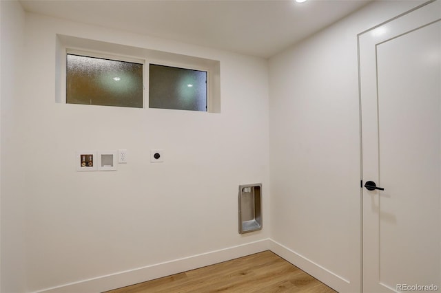 clothes washing area with washer hookup, hookup for an electric dryer, and light hardwood / wood-style floors