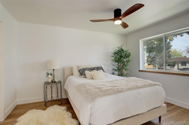 bedroom with hardwood / wood-style floors and ceiling fan