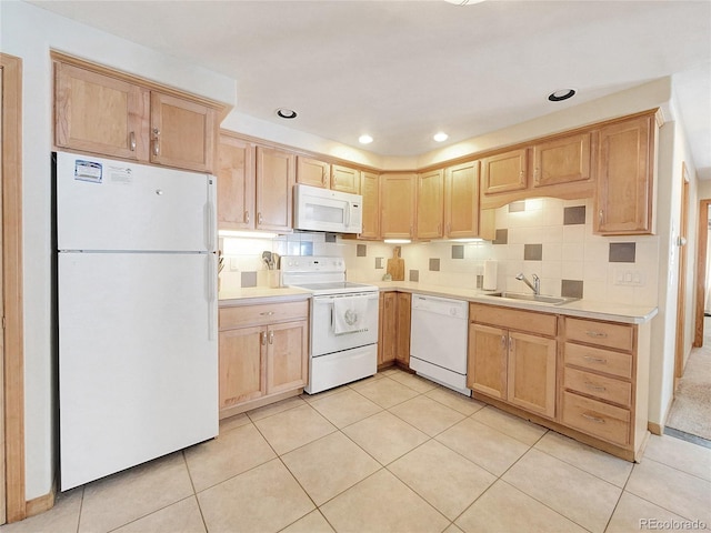 kitchen featuring light tile patterned flooring, white appliances, and sink