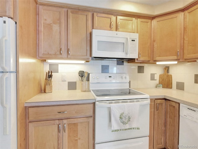 kitchen with decorative backsplash, light brown cabinetry, and white appliances