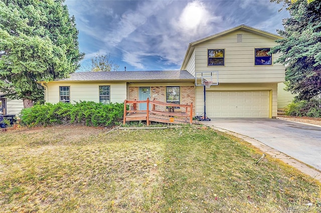 split level home with a front lawn and a garage