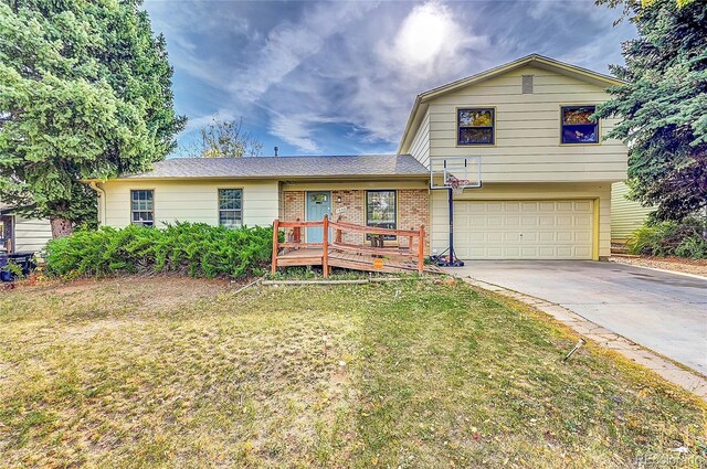 1550 S Telluride St, Aurora, CO 80017 - tri-level home featuring an attached garage, brick siding, a front lawn, and driveway