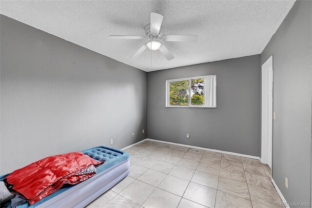 1550 S Telluride St, Aurora, CO 80017 - bedroom with a textured ceiling, baseboards, a ceiling fan, and marble finish floors