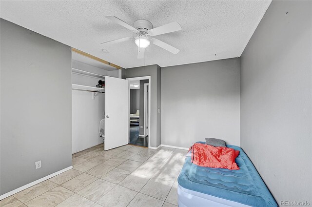 1550 S Telluride St, Aurora, CO 80017 - bedroom featuring a textured ceiling, baseboards, a ceiling fan, and marble finish floors