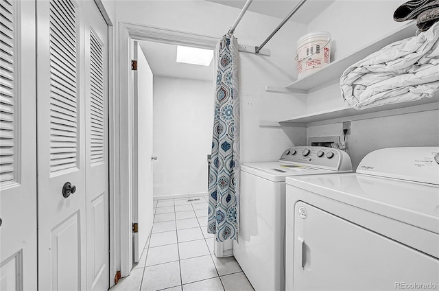 laundry area featuring separate washer and dryer and light tile patterned floors