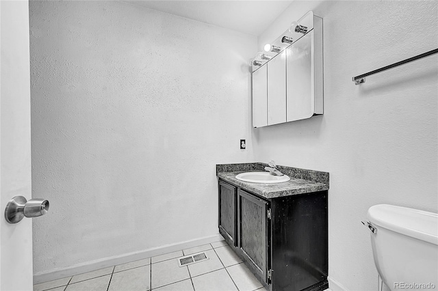 bathroom featuring vanity, toilet, and tile patterned floors