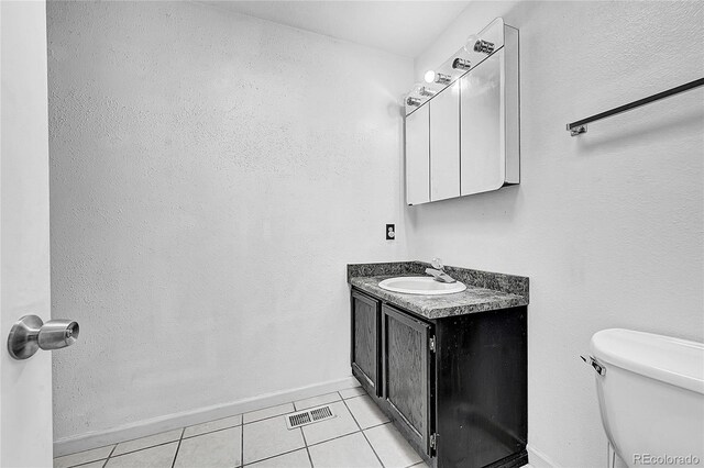 1550 S Telluride St, Aurora, CO 80017 - bathroom with tile patterned flooring, baseboards, vanity, and toilet